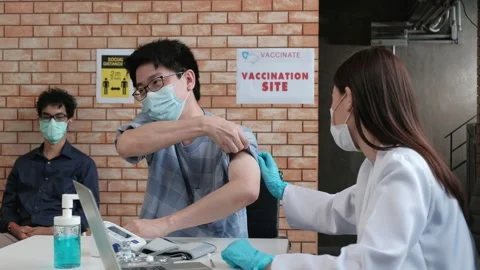 Asians people queue for prevention coronavirus (COVID-19) vaccinations. Stock Footage 158003539