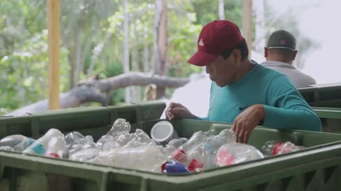 Asiatic men in respirators sort garbage. sorts plastic bottles Stock Footage 230700931