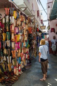 Asilah, Morocco - August 14 2013: Unidentified young woman looking at many Stock Photos