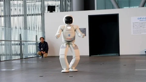 Asimo humanoid robot walking and gesticulating in Miraikan museum Stock Footage 107633922