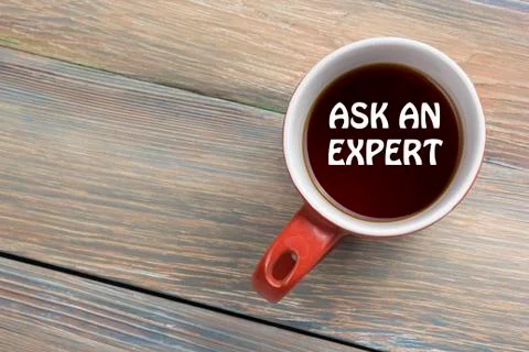 Ask an expert. Coffee cup with message. Office desk table top view Photos