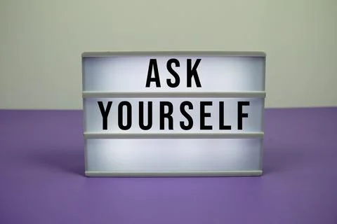 Ask Yourself text on light box on purple background Stock Photos