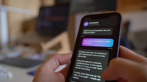 Asking AI assistant how to say a phrase in French on smartphone close-up 스톡 동영상 342129241