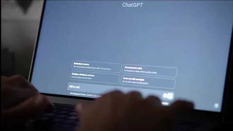 Asking Chat GPT, "Will AI replace Human Beings?" Hands type on laptop. Stock Footage 253495238