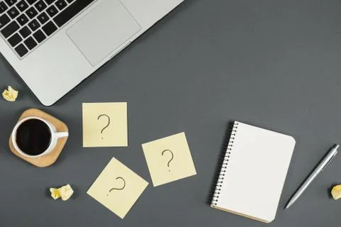 Asking, Decisions. Question mark on sticky notes, notebook, cup coffee Stock Photos