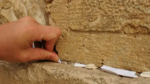 Asking for desire at the Western Wall of Jerusalem Stock Footage