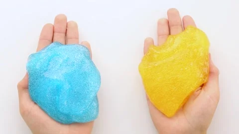 Asmr. Multicolored mucus slowly spreads in the palms of a person. A sticky, Stock Footage 250360198
