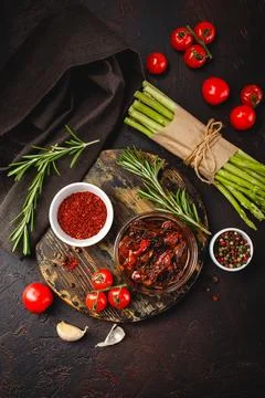 Asparagus and tomatoes on rusticbackground Stock Photos