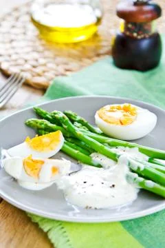 Asparagus with boiled eggs Stock Photos