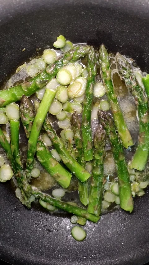 Asparagus is fried in a pan Video stock 310327071