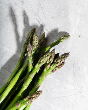 Asparagus on marble background. hard light food photography. Healthy eating c Stock Photos