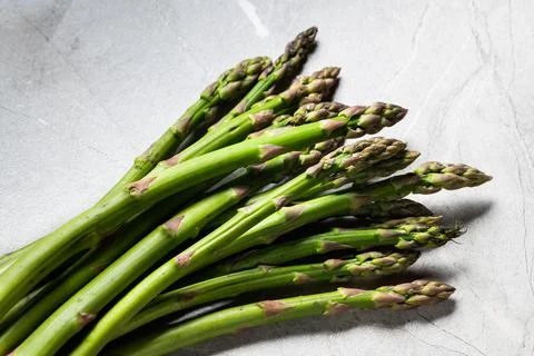Asparagus on marble background. hard light food photography. Healthy eating c Stock Photos