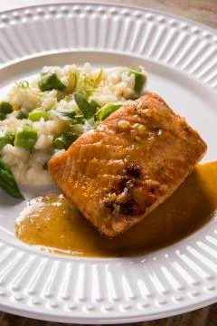 Asparagus risotto with grilled salmon Stock Photos