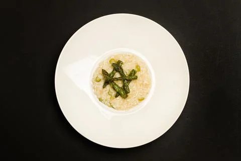 Asparagus risotto in a white ceramic plate in a top view Foto stock