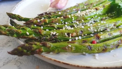 Asparagus roasted on gray concrete background, slow motion Stock-Footage 107978448