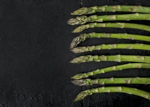 Asparagus on rustic black background Stock Photos