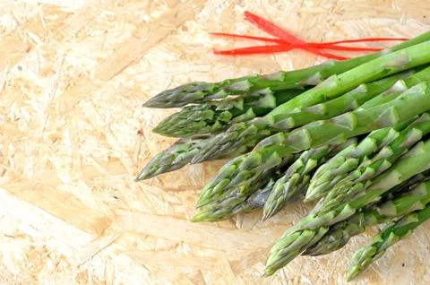 Asparagus scattered on the kitchen table Stock Photos
