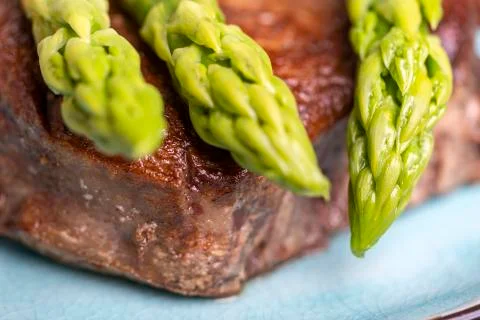 Asparagus with a steak Stock Photos