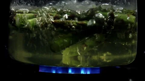 Asparagus tips being cooked in hot water Stock Footage 8573675