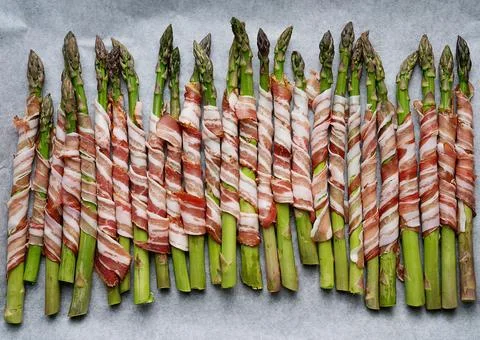Asparagus wrapped in bacon. Stock Photos