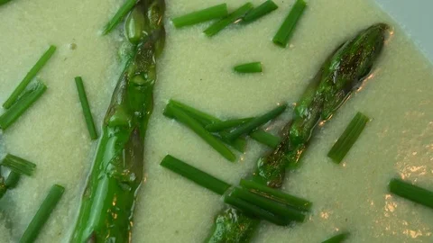 Aspargus soup with wild chive in a white soup plate Stock Footage 73417853