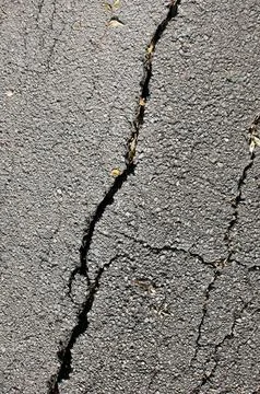 Asphalt with crack Stock Photos