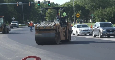 Asphalt Crew - Plate Compactor over Fresh Asphalt Stock Footage 78554610