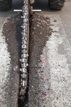 Asphalt cutting machine slicing up a section of the road Stock Photos