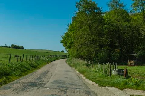 Asphalt empty road passing through the fields in the region of Normandy, France 스톡 사진