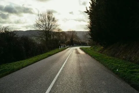 Asphalt empty road passing through the fields in the region of Normandy, France Stock Photos