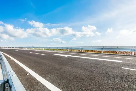 Asphalt highway and sky cloud landscape under blue sky. Stock Photos