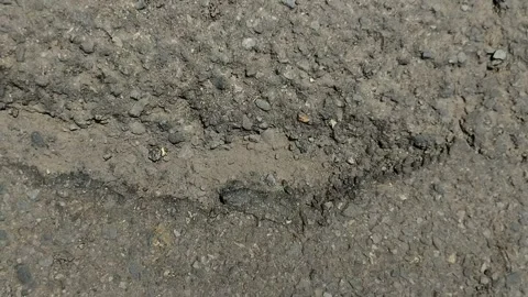 Asphalt on the highway is peeling Stockbeeldmateriaal 305977720