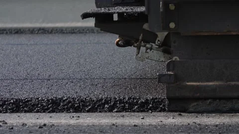 Asphalt layer spread over roadway and screeded by road paver finisher Stock Footage 158040893