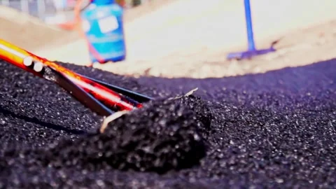 Asphalt leveling process from ground view showing road construction work and Vídeos de archivo 332609109