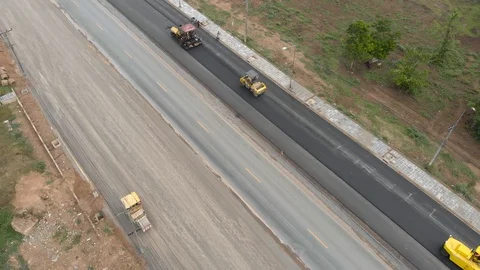 Asphalt machine and steamroller operator job Stock-Footage 88360484