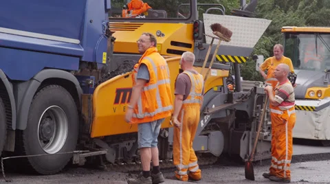 Asphalt machine is fed by dump truck Stock Footage 37433557