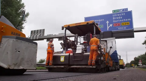 Asphalt machine laying a fresh layer of asphalt with roller machine behind Stock Footage 37433593