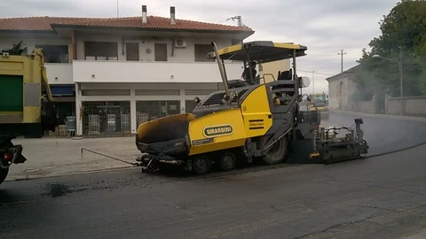 Asphalt machine at work to repair an old road Stock Footage 88677640