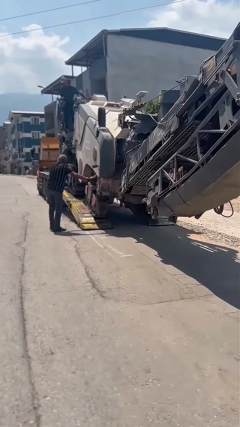 Asphalt Milling Machine Unloading from Lowbed Trailer Stock Footage 323654005