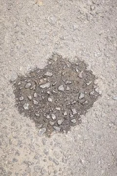 Asphalt patch with rough texture contrast Stock Photos