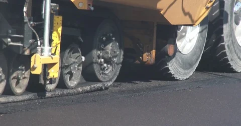 Asphalt Paver Moving Forward - CU of Wheels Stock Footage 78554434