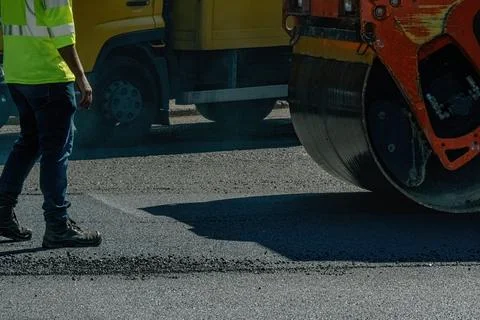 Asphalt paver at work close up Stock Photos