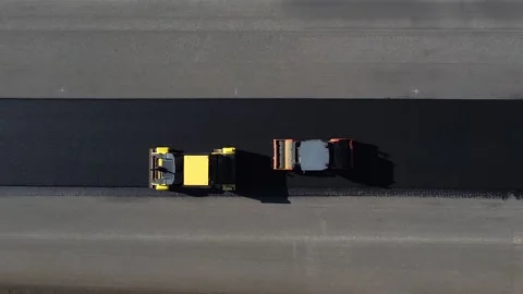 Asphalt pavers in progress, drone view of laying new asphalt road Stockbeeldmateriaal 196218031