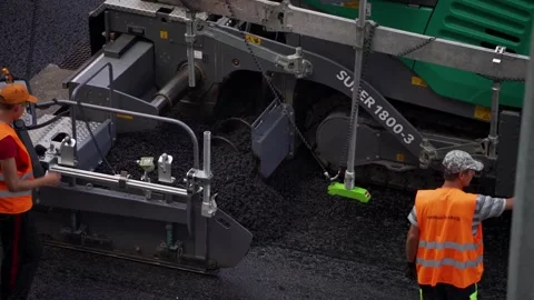Asphalt paving machine adding new asphalt for road construction. Stock Footage 314134354
