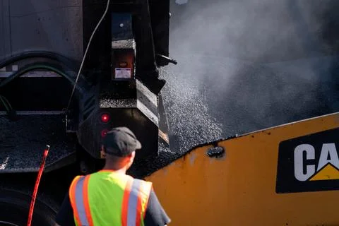 Asphalt paving machine and worker in Brooklyn Fotos de archivo