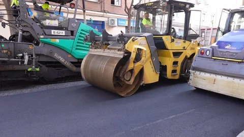 Asphalt paving machine, road roller and compactor machine working together Stock Footage 253230482