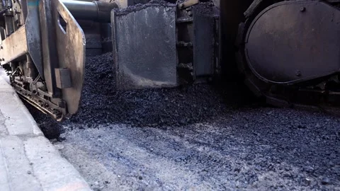 Asphalt paving machine throwing fresh warm mix asphalt close-up Vídeos de archivo 253230420