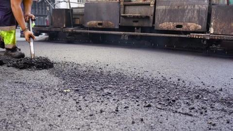 Asphalt paving machine view from behind and road workers treating WMA 2 스톡 동영상 253230430