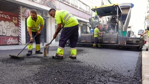 Asphalt paving machine view from behind and road workers treating WMA 스톡 동영상 253230478