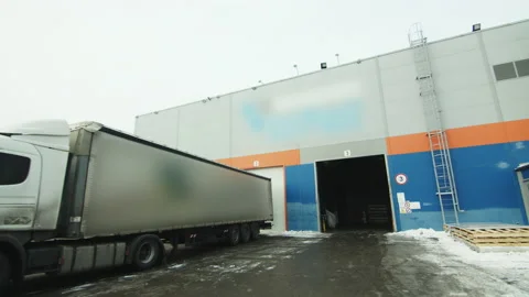 Asphalt ramp with trucks and pallets near warehouse Stock Footage 228780745